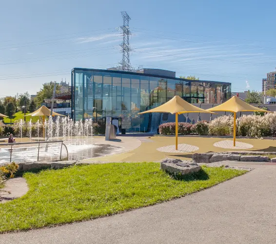 water spout fountain and umbrella patio exterior of glass building