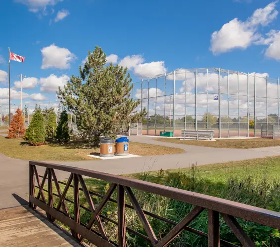 baseball diamond, bridge walkway,garbage can, canadian flag