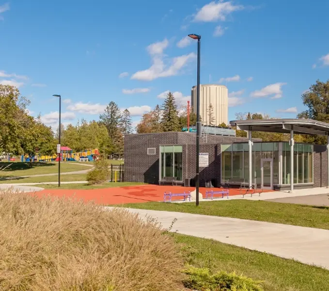 community building sidewalk with park in background